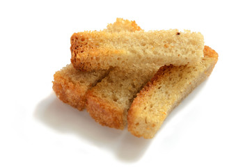 Several rusks in the form of straws. On a white background with selective focus.