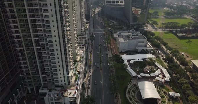 Forward aerial flight alongside skyscrapers following main avenue line. Business district area. Drone, 4K. 

Frame rate: 23.98
Video Codec: ProRes 422HQ
Bonifacio Global City, BGC
Manila, Philippines
