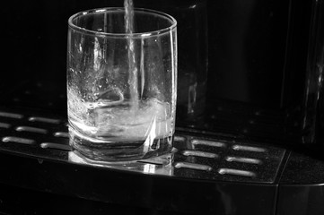 cold water drop to glass from black plastic cooler