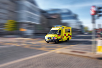 Ambulance responding to emergency call driving fast on street