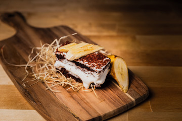 A chocolate sponge-cake with vanilla cream and banana