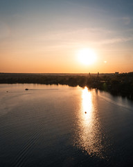 Obraz premium Orange sunset on the wide river in summer