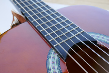 Obraz premium Acoustic guitar background and strings. Children's classic guitar. Soundboard and vulture.