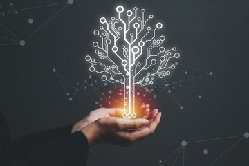 The concept of an electronic tree panel in the hand of a growing business woman.