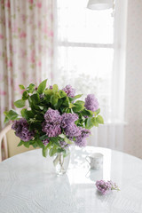 Fototapeta na wymiar a bouquet of lilacs on the table in the room