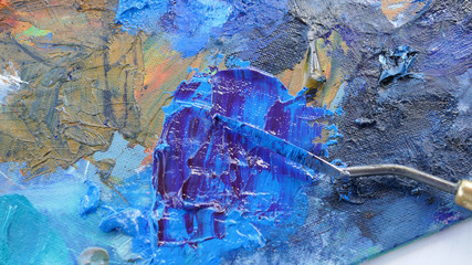 Artist, palette with paints, brushes and a palette knife on a white background.