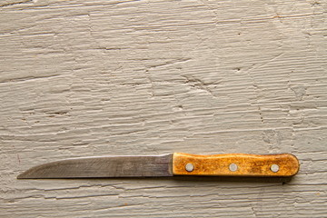 A very old kitchen knife that was grinded off from constant use on a rough wooden board