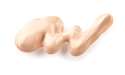 Liquid foundation cream swatch smear. Light beige makeup concealer stroke isolated on white background with clipping path included without shadows. Nude makeup base swipe