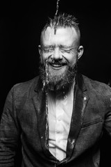 Portrait of an attractive young businessman in black background wearing suit and necktie. Classic style. Studio shot