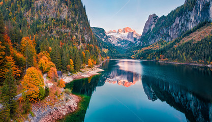 View from flying drone. Captivating autumn view of Gosausee (Vorderer) lake with Dachstein glacieron background. Spectacular evening scene of Austrian Alps, Upper Austria, Europe.