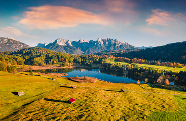 View from flying drone. Astonishing evening view of Wagenbruchsee (Geroldsee) lake with Westliche Karwendelspitze mountain range on background, Bavarian Alps, Germany, Europe.