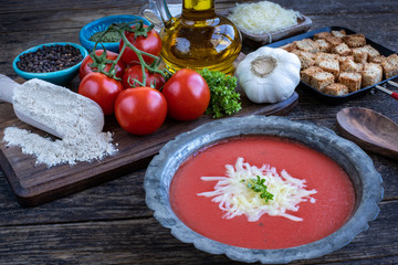 Tomato soup with cheese on the table