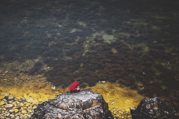 kid on the rocks near the sea