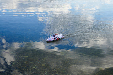 Children's toy, remote control boat, Toy boat floating in the water.