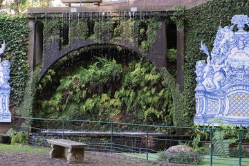 Green wall, waterfall and azulejos in Monte Palace Tropical Garden, Funchal, Mount Monte, Madeira,...