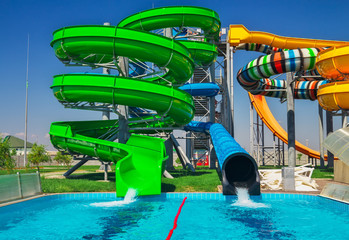 Colorful aquapark slide with pool for everyone. Happy holidays on vacation