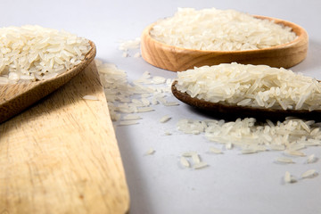 Raw white rice in spoon,close-up
