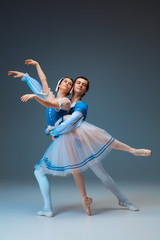 Young and graceful ballet dancers as Cindrella fairytail characters on studio background. Art, motion, action, flexibility, inspiration concept. Flexible caucasian ballet dancers in inspired dancing.