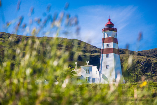 Alnes lighthouse at clear sumer sky at Godoy island near Alesund, Norway