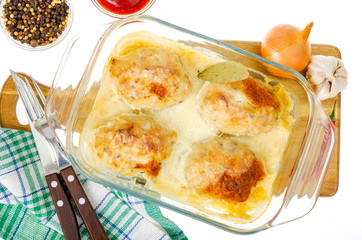 Meat dishes, form with cutlets in white sauce