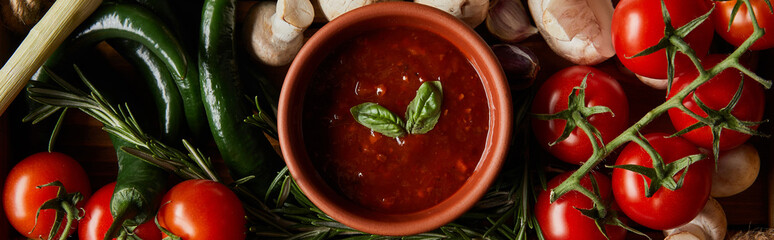 panoramic shot of tomato sauce with basil leaves near cherry tomatoes, green chili peppers, mushrooms and rosemary