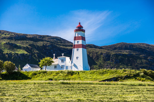 Alnes lighthouse at clear sumer sky at Godoy island near Alesund, Norway