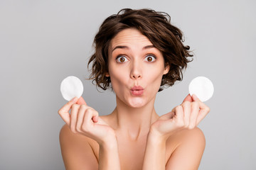 Closeup photo of beautiful naked lady short bob hairdo hold two cotton disks pad removing makeup...