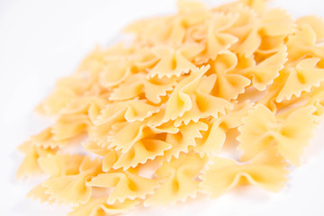 Raw Farfalle pasta on a white background