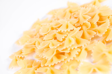 Raw Farfalle pasta on a white background
