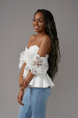 Fashionable girl wearing casual white top and blue jeans. Young african woman, Female model with...