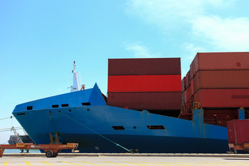 Large loaded Container ship docked at port.