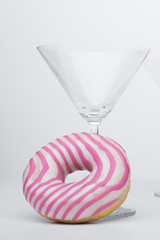  Martini glass and pink donut. Close-up. - 353353432