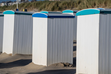 Empty beach houses cabins along the shore and on the beaches are empty.