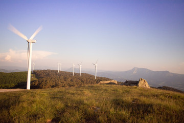 wind eolic generators on the mountains in the basque country at sunset
