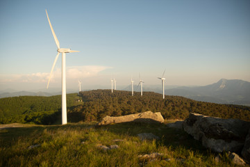 wind eolic generators on the mountains in the basque country at sunset