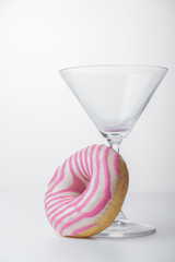  Martini glass and pink donut. Close-up. - 353355663