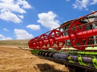 Combine harvester parked in a large Wheat field.