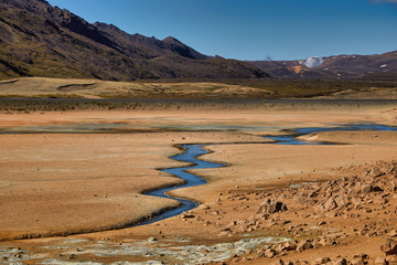 Natural steam rising from volcanic vents in the earth. Namafjall - geothermal area in field of...