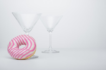  Martini glass and pink donut. Close-up. - 353356433