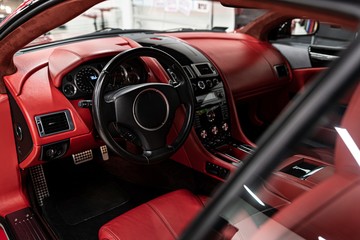 Red leather seats in car. Modern luxury sport car interior.