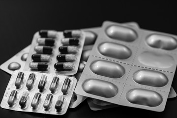 Close up of different types of painkillers, antibiotics, vitamins tablets blisters  isolated.