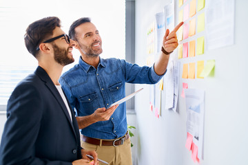 two businessmen at office discussing project