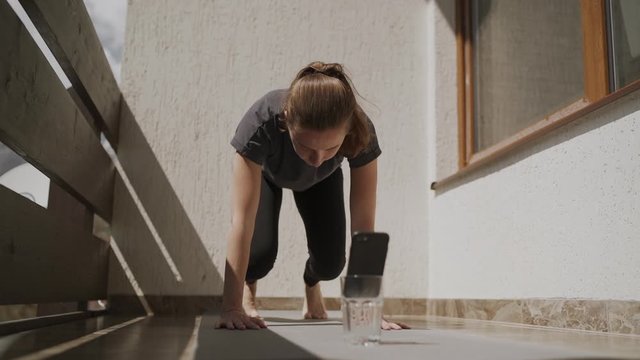 Woman Practicing Online Yoga At Home