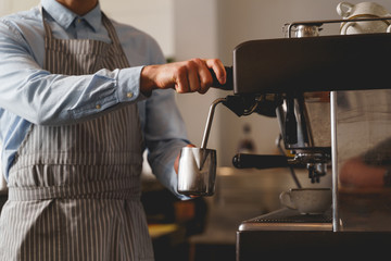 Bartender making fresh coffee with professional coffee machine