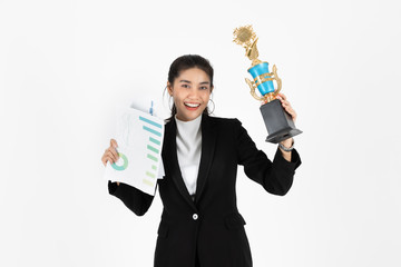 Successful young Asian business woman celebrating with trophy award over white isolated background....