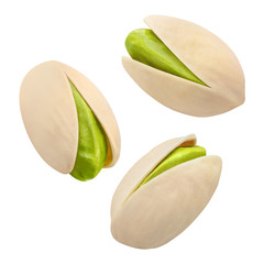 Close-up of flying delicious pistachios, isolated on white background