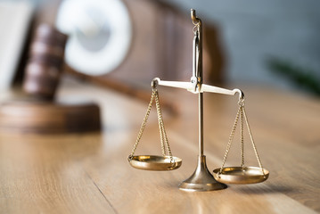 Law and Justice concept. Gavel of the judge, books, scales of justice. Gray stone background.