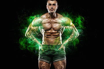 Athlete in green energy lights. Muscular young fitness sports man bodybuilder. Workout in fitness gym. Copy space for fitness nutrition ads.