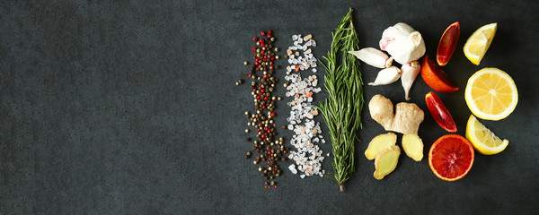 Set of seasonings and spices on a black stone board. Food background. Healthy food concept. Spices...