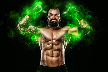 Fototapeta na wymiar Athlete in green energy lights. Boxer bodybuilder in boxing gloves celebrating flawless victory. Sport concept isolated on black background.